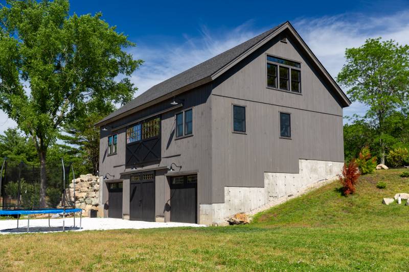 Side view showing the side and back of the barn with walk-out level