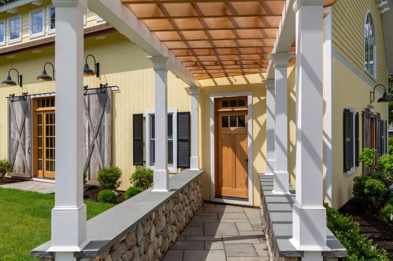 Pergola covered walkway to the family barn