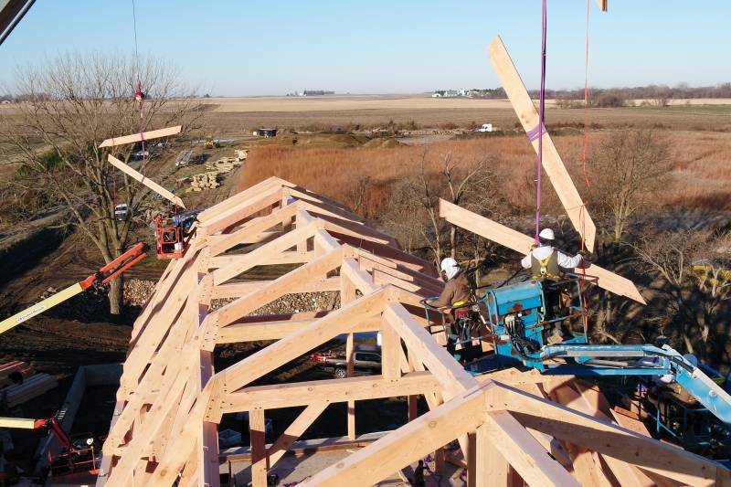 Timber framers setting the rafters