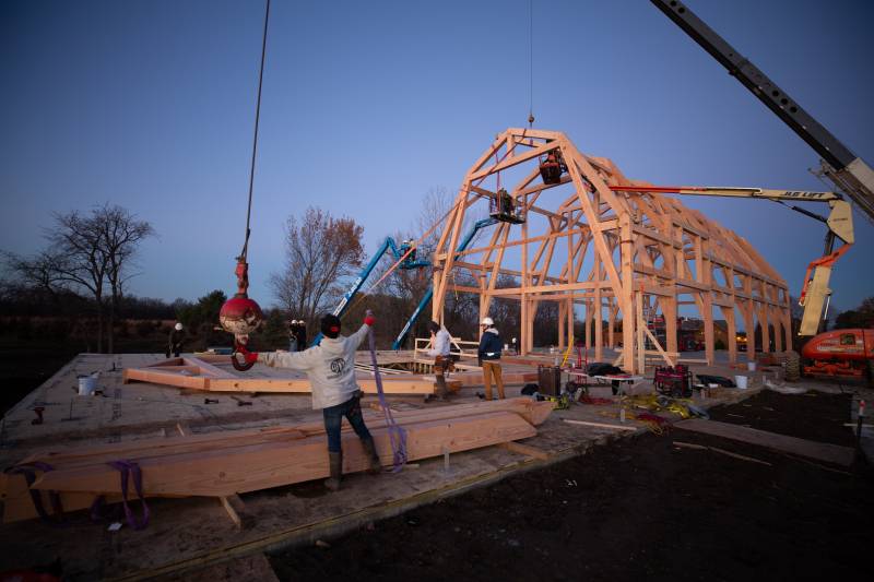 Signaling to the crane operator to lift the heavy beam