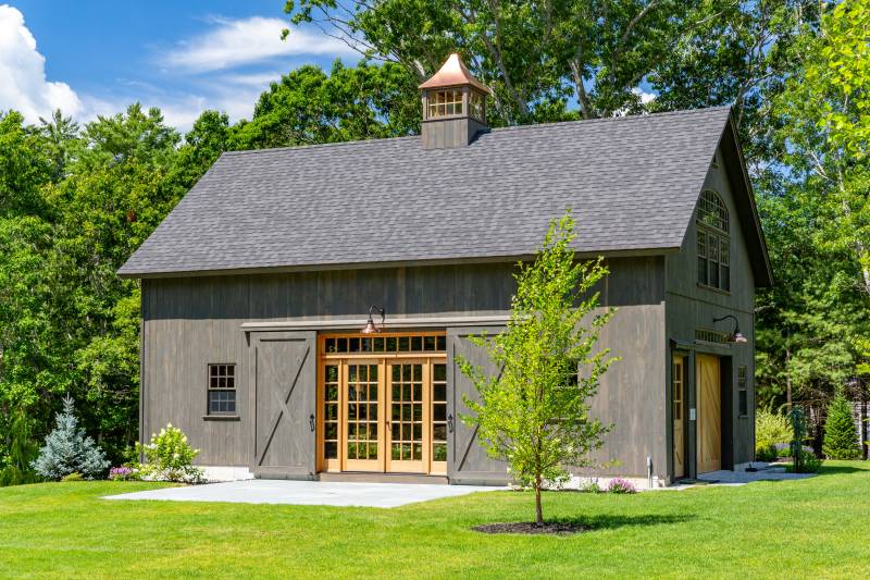 10' x 9' Split Sliding Barn Door with Covered Track • 6' x 7' Spanish Cedar Entry Door with 15 Lite Full Glass, Side Lites, and Transom