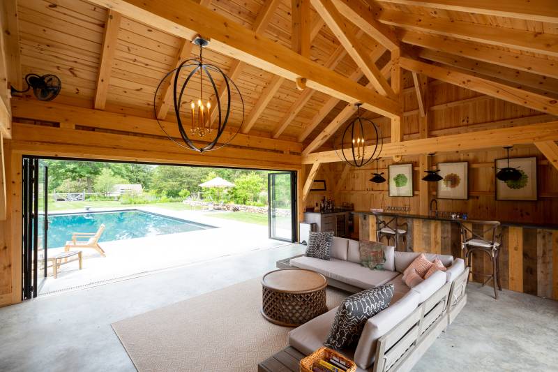 custom pool house with rustic barnwood bar