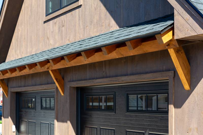 Timber Frame Eyebrow Roof above Overhead Doors