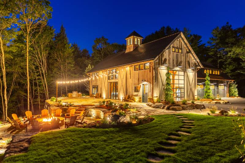 A Firepit and Patio Outside of the Party Barn