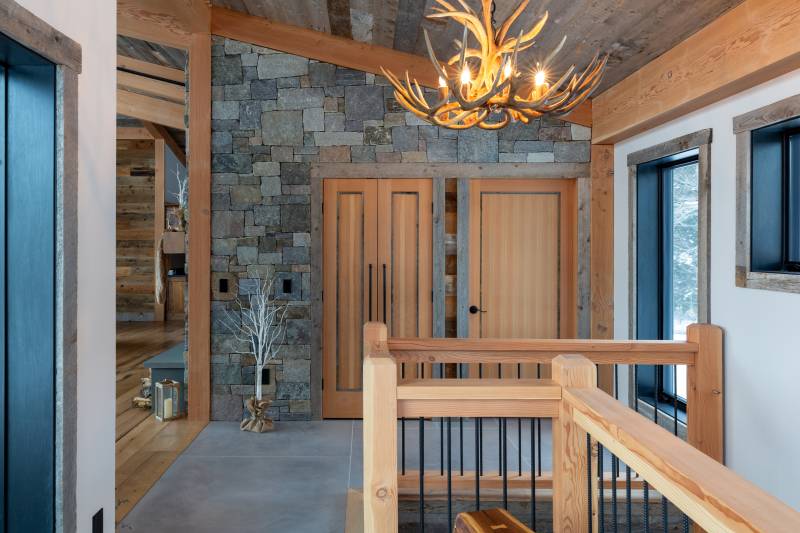 The Foyer • Natural Fieldstone Accent Wall • Stairs Lead to Lower Level