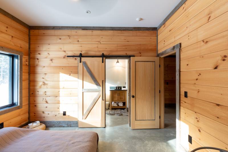 Bedroom • Sliding Barn Doors Reveal a Bathroom 