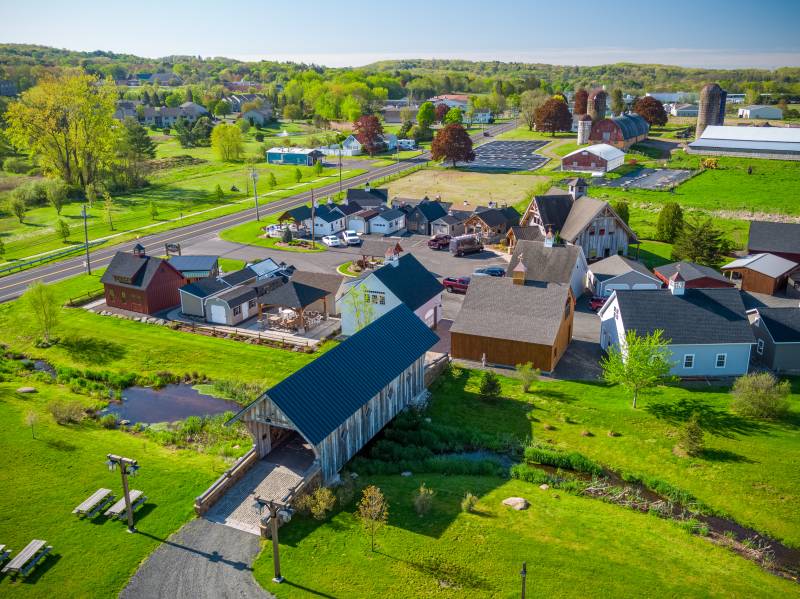 Take a Stroll over The Barn Yard Covered Bridge to our Showcase