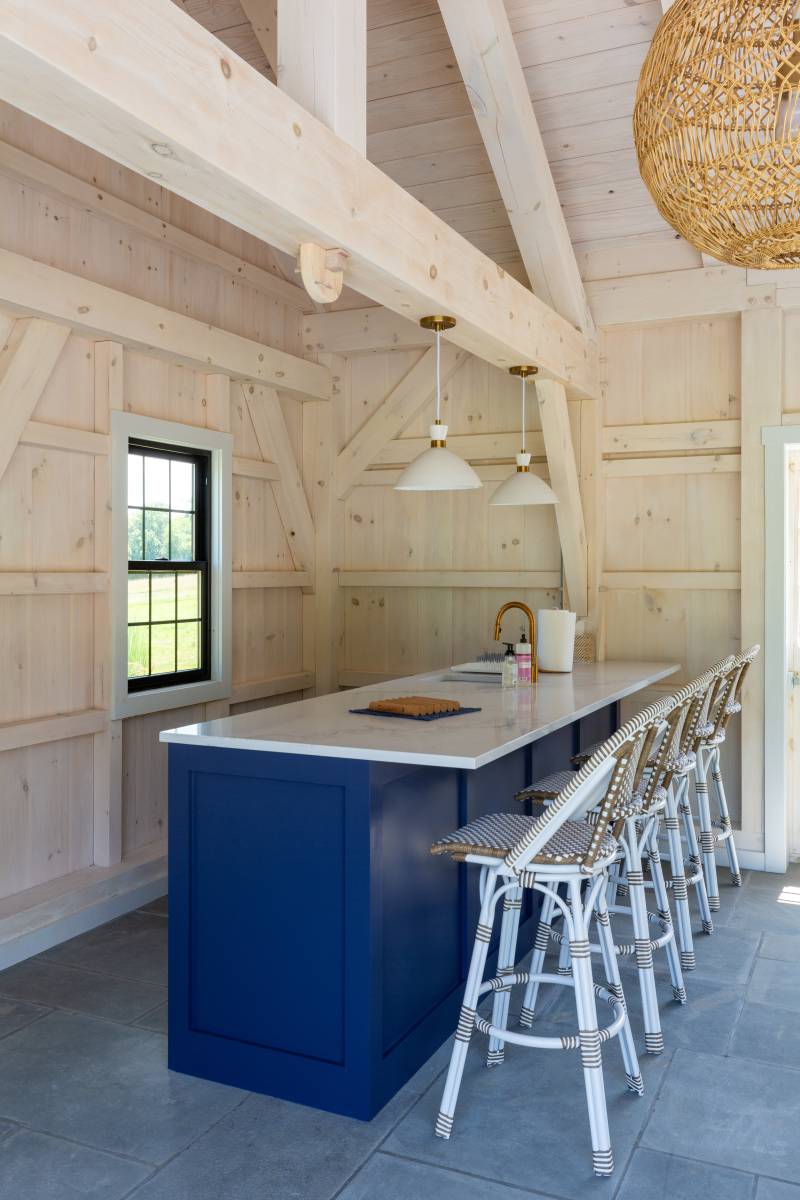 Bright Blue Cabinetry Pops Against the Light Timbers • Pool House