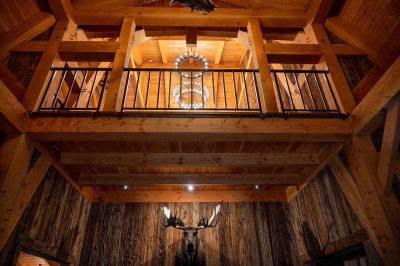 Looking Up at the Balcony • Custom Timber Frame Barn 