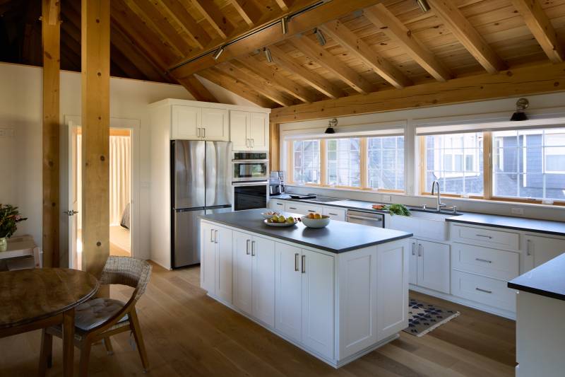 The kitchen in one of the 20' shed dormers • rustic barn home barndominium