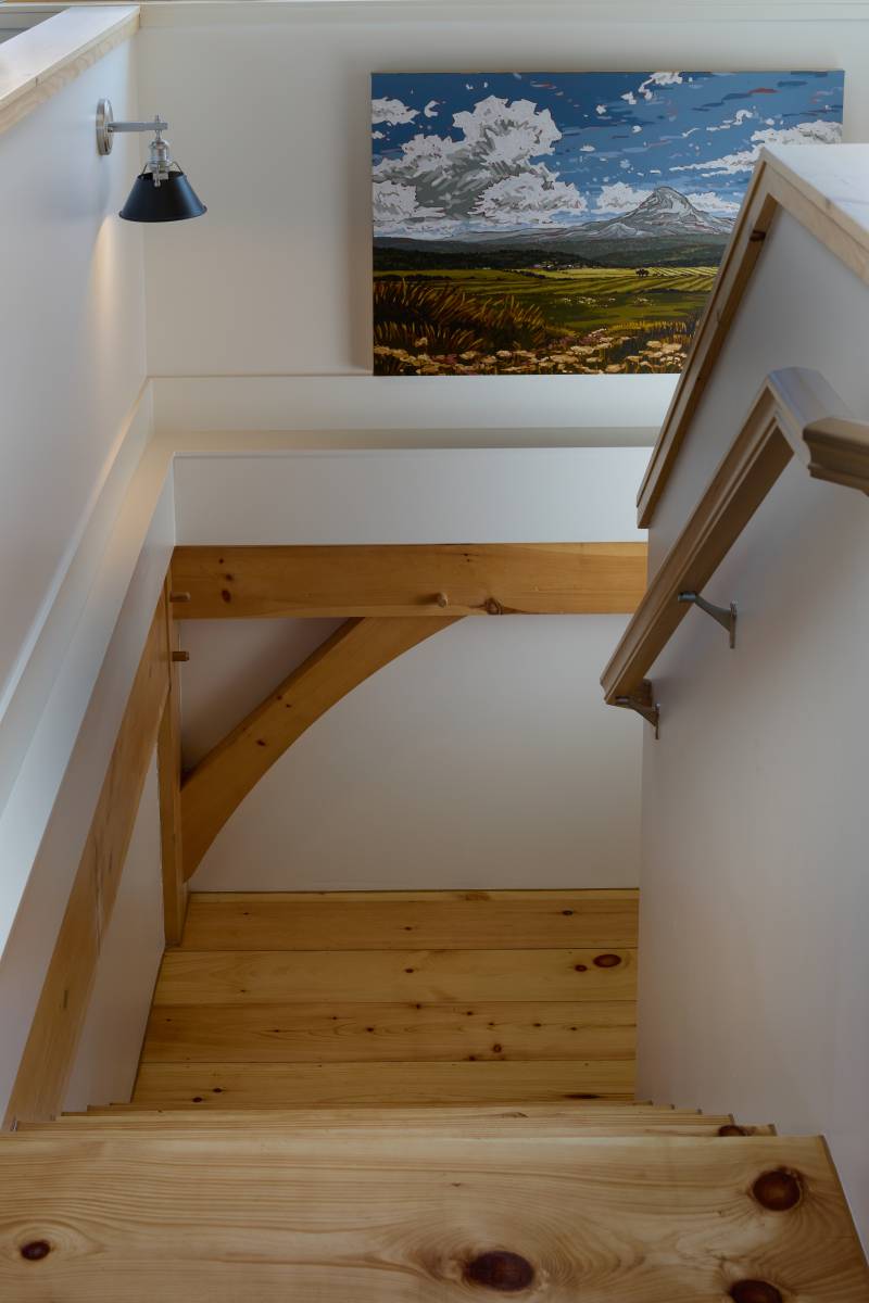 Heading downstairs to the first floor garage • post & beam timber frame home