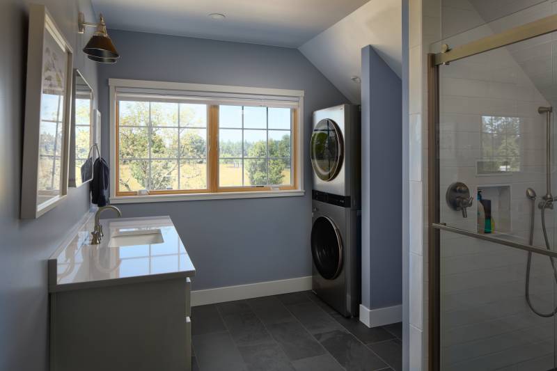 A full bathroom, plus laundry space in the timber frame barn home • barn living