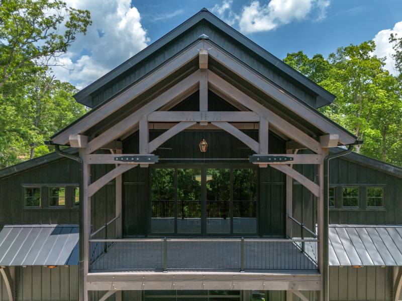 Gable portico roof with deck joists • Back deck of the barn