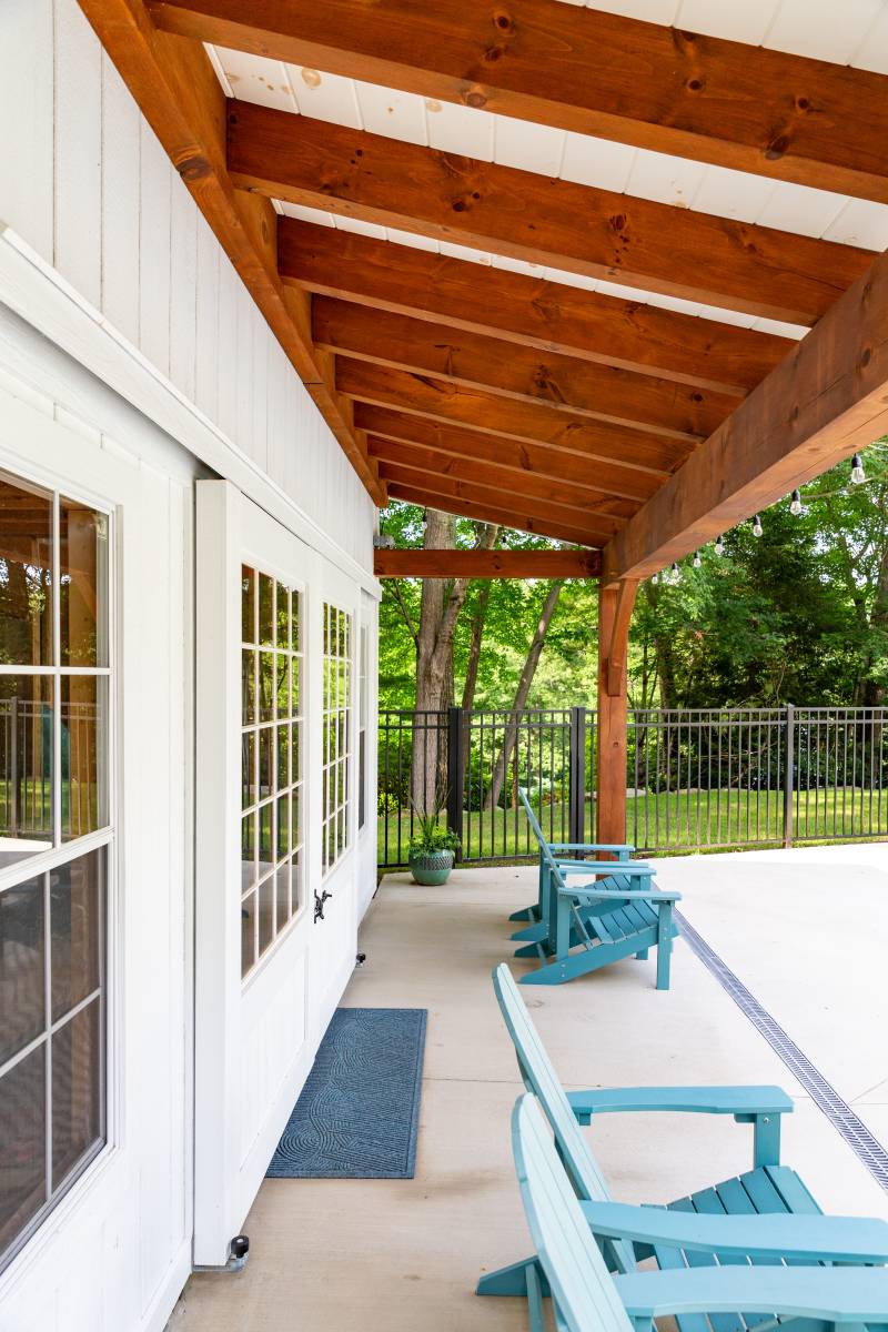 Underneath the timber frame overhang on the poolhouse shed