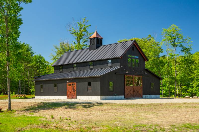 Pine barn doors lead into the post & beam barn • timber frame barn