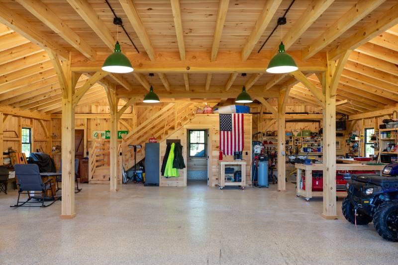 Full bathroom underneath the stairs to the barn’s second floor loft • post & beam barn living timber frame builders