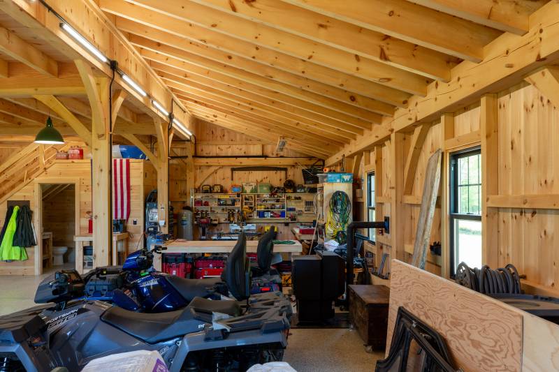 The back corner of the post & beam barn is a workshop • timber frame barn interior