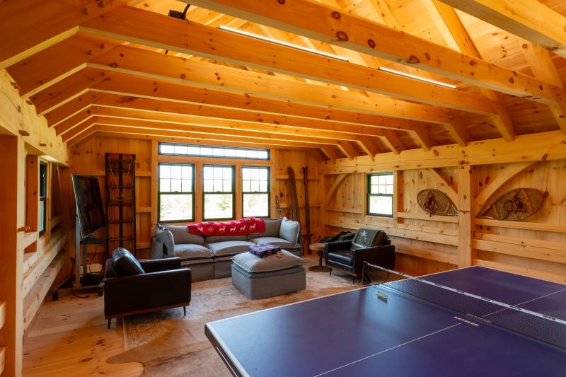 Ping pong table and seating area in the post & beam barn loft