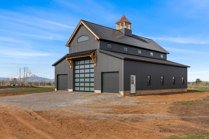 Timber Frame Eyebrow Roof above the post & beam barn’s overhead door