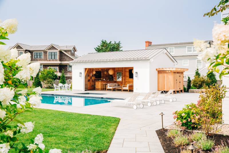 Luxury timber frame pool house in a Rhode Island backyard