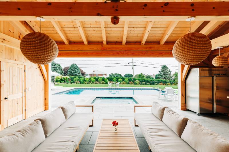 Looking out towards the pool • post & beam backyard pool house outdoor living