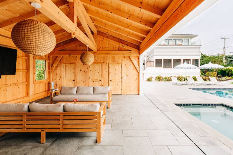 Relax by the pool in a luxurious timber frame pool house