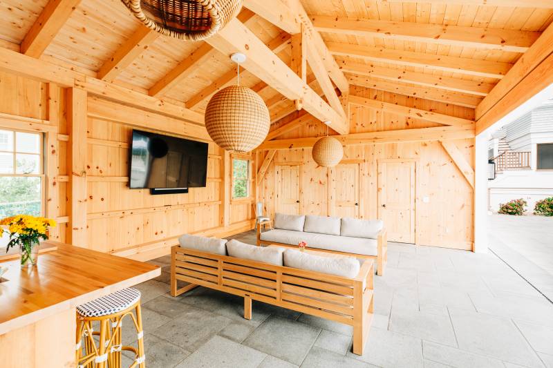 Seating area and TV in the post & beam pool house