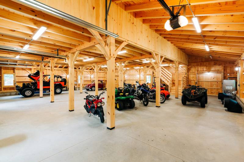 Underneath one of the lean-tos looking into the timber frame barn