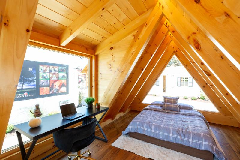 12' x 18' A-Frame Cabin interior with space for a queen-size bed and a desk