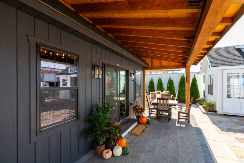 Underneath the timber frame overhang • 6' Insulated Slider Door leads inside
