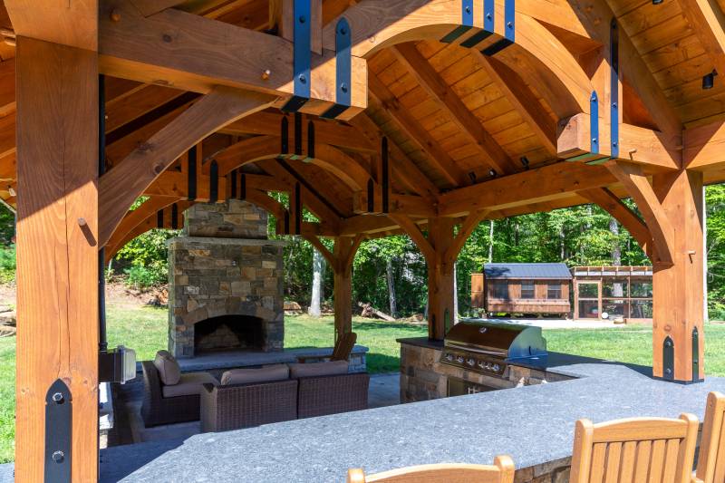 Alpine Timber Frame Pavilion with bar, seating area, and fireplace