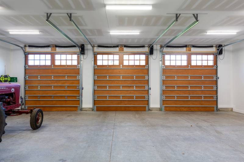 Three overhead doors lead to the first floor garage • ADU
