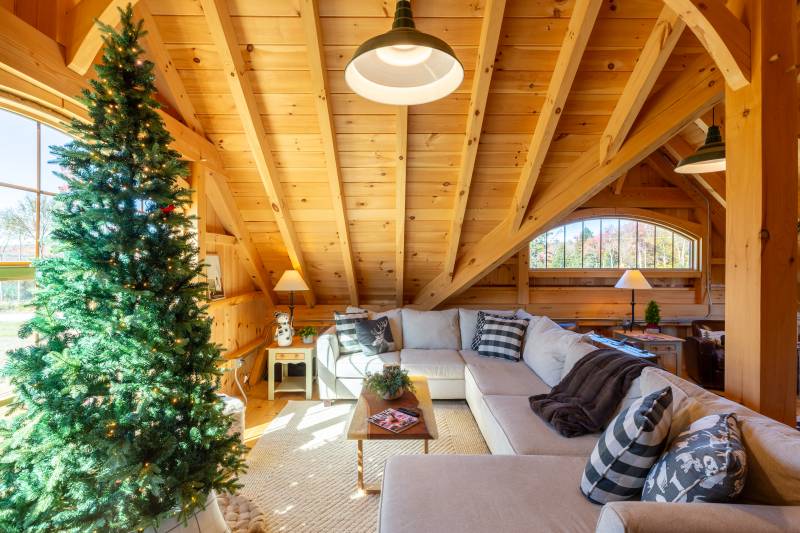 A couch overlooks the bay window in the gable