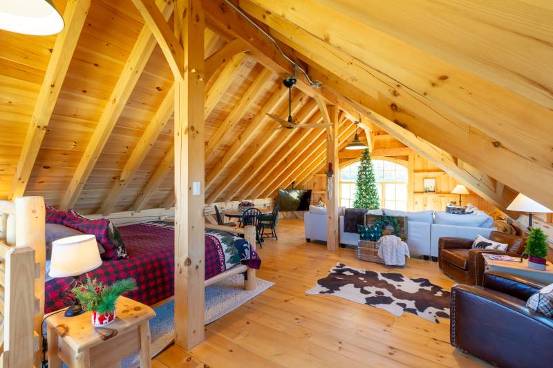 A wide view of the loft interior • Bed, seating, and living area