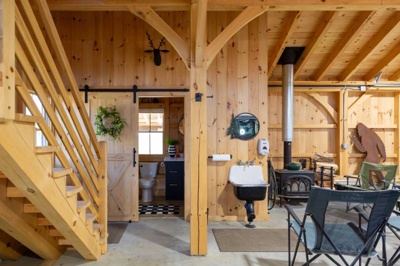 Entrance to the bathroom • Wood stove on the right