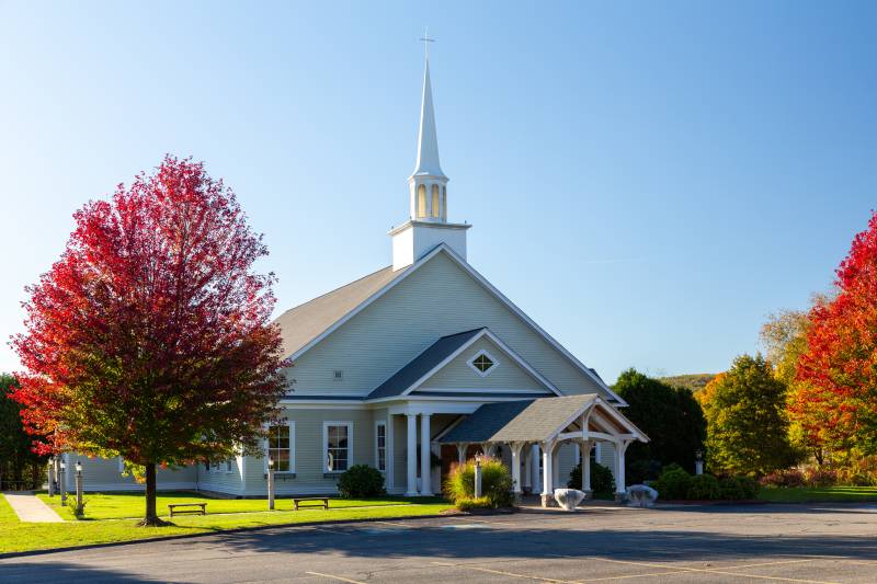 The pavilion blends in as a rustic covered entry for the church
