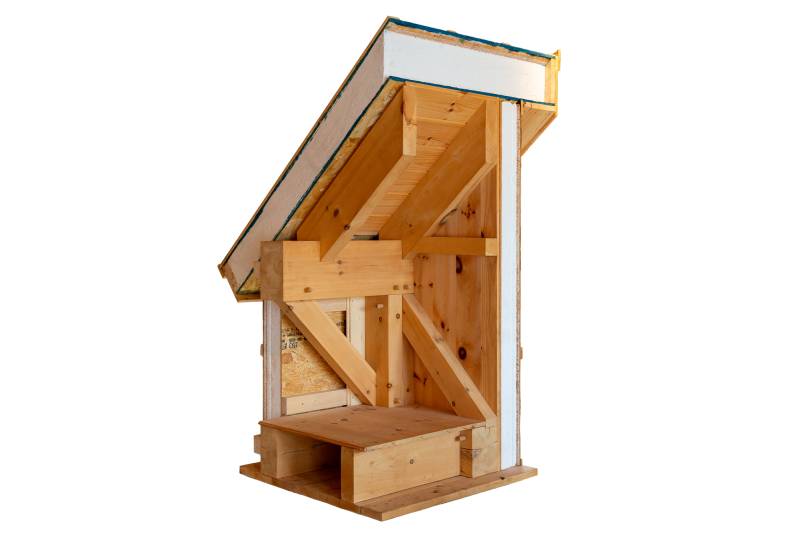 SIPs are installed on the exterior of the frame, leaving the timbers fully exposed and visible on the interior