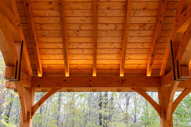 Lighting hidden within the pavilion illuminates the timber rafters & roof decking