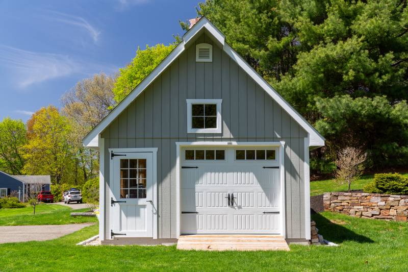 The garage has an 8' x 7' Carriage Style overhead door with square glass and a 3' single door with half glass
