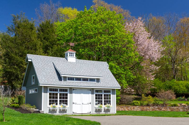 The garage is surrounded by spring blooms