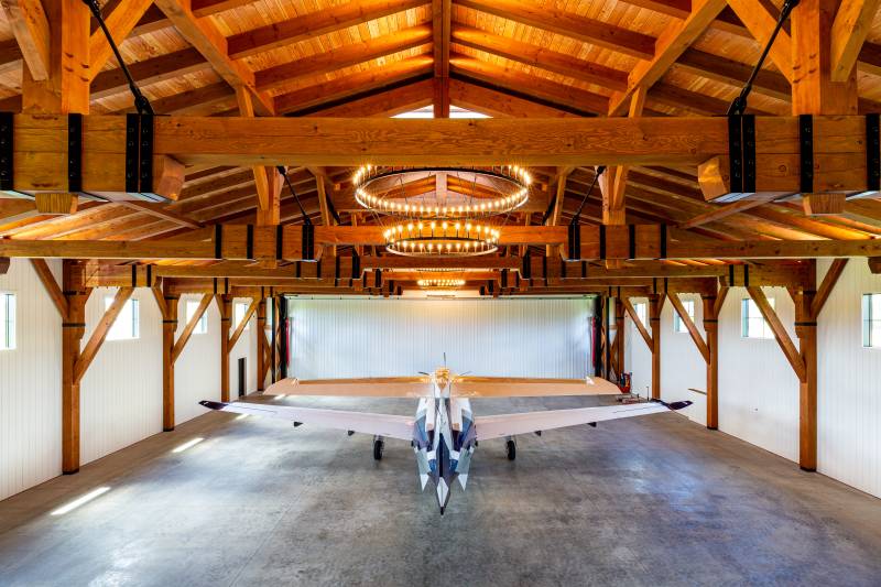 76' clear span queen post timber trusses with powder coated steel angled turnbuckles & metal strapping