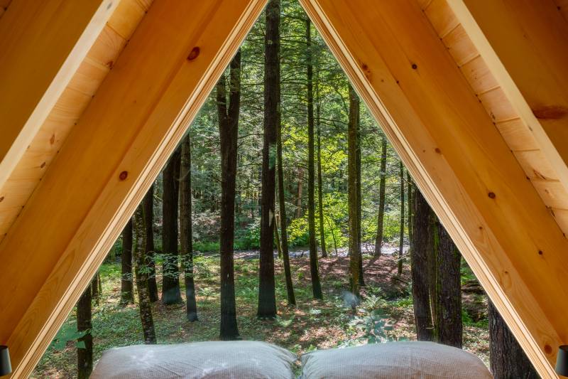 The large picture window offers guests a view of the adjacent brook