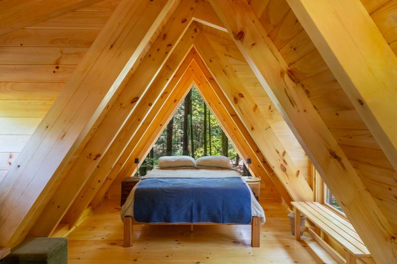 A queen bed fits comfortably within the cabin