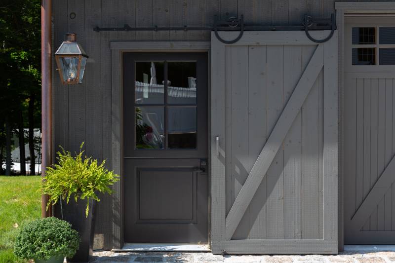 A sliding barn door conceals the entry door