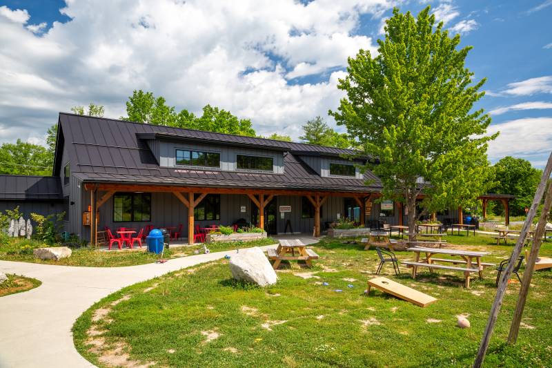 A gathering green in front of the timber frame community center