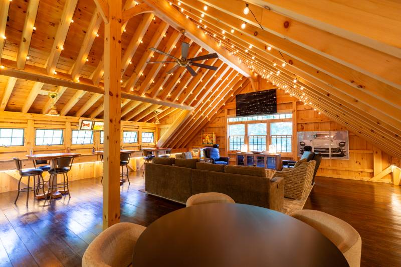 String lights run alongside the timber rafters in the loft