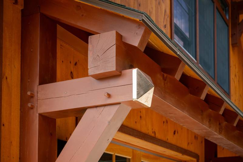 A closeup of the metal accents on the timber frame eyebrow roof