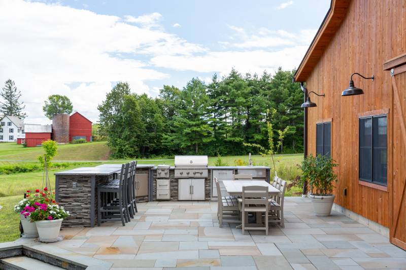 An outdoor kitchen and patio just outside the barn