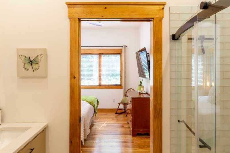 Looking from the full bathroom into the bedroom