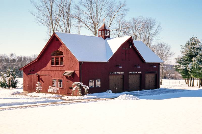 The red siding stands out in the snow